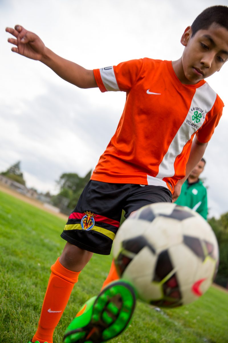 boy playing soccer